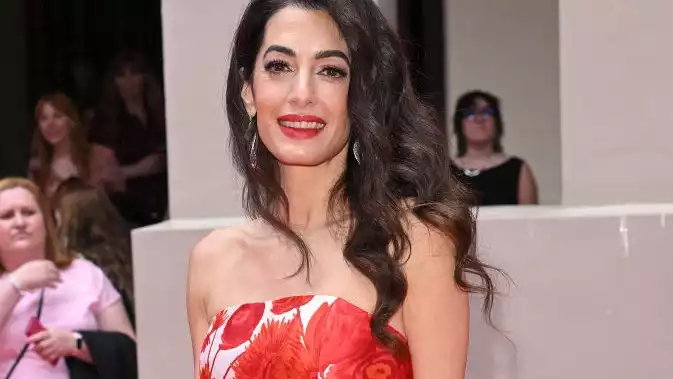 Amal Clooney in a red floral dress at the Prince's Trust Awards