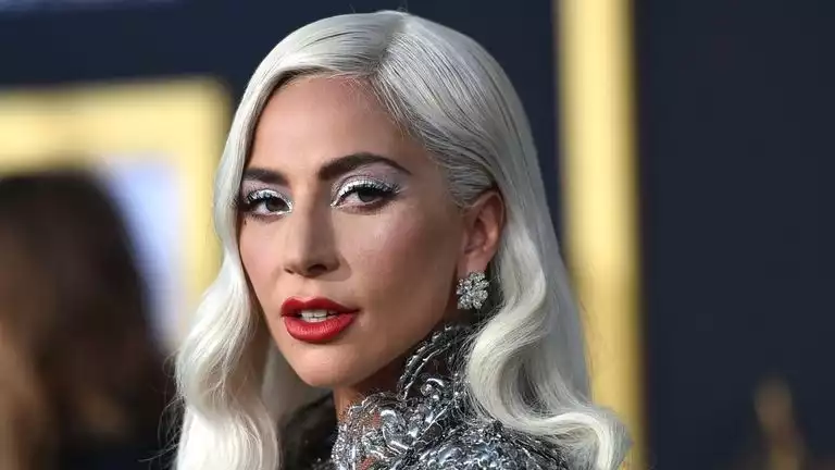 Lady Gaga with bleached eyebrows and no makeup.