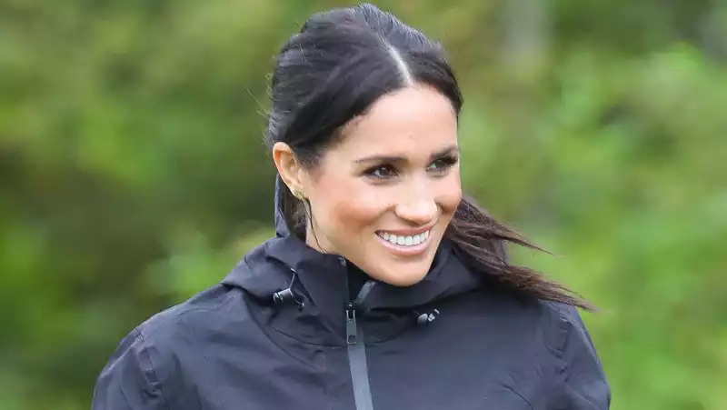 Meghan Markle pictured smiling on a hike with Archie and her dogs